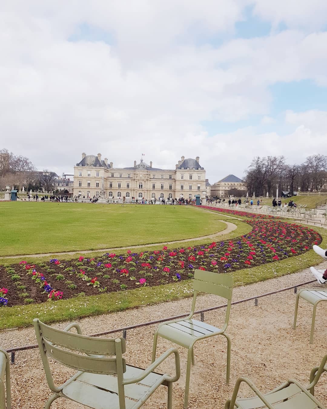 family on a bench in Luxembourg garden